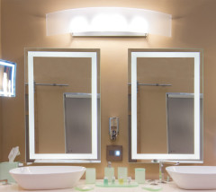 Hotel bathroom with lighted magnified mirrors